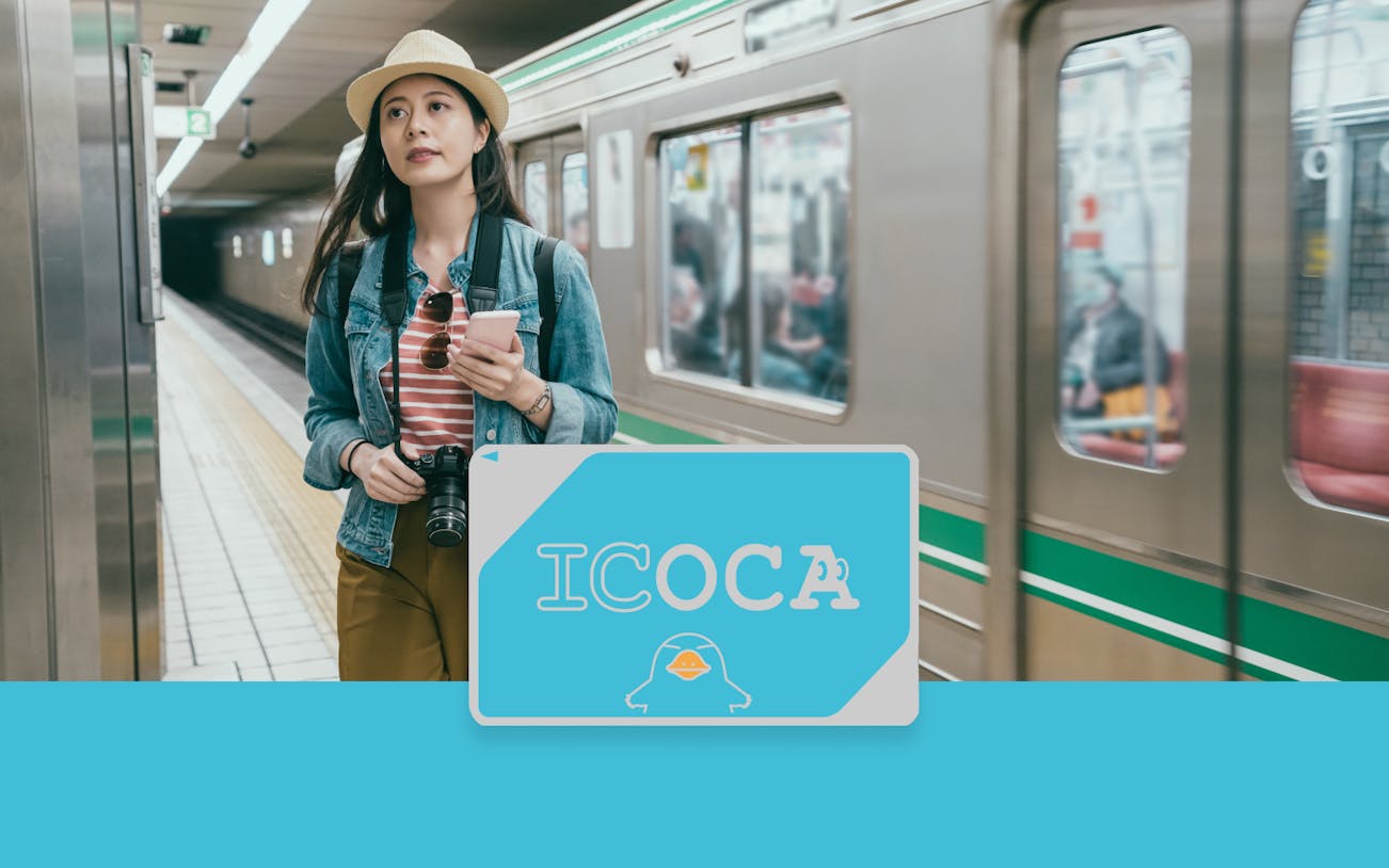 Traveler using ICOCA IC Card at a train station in Japan.