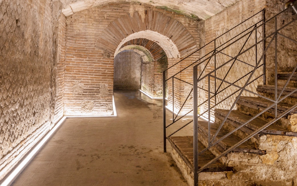 Underground Roman theater ruins with brick arches in Naples, Napoli Sotterranea tour.