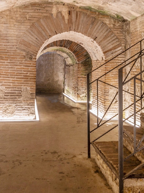 Underground Roman theater ruins with brick arches in Naples, Napoli Sotterranea tour.
