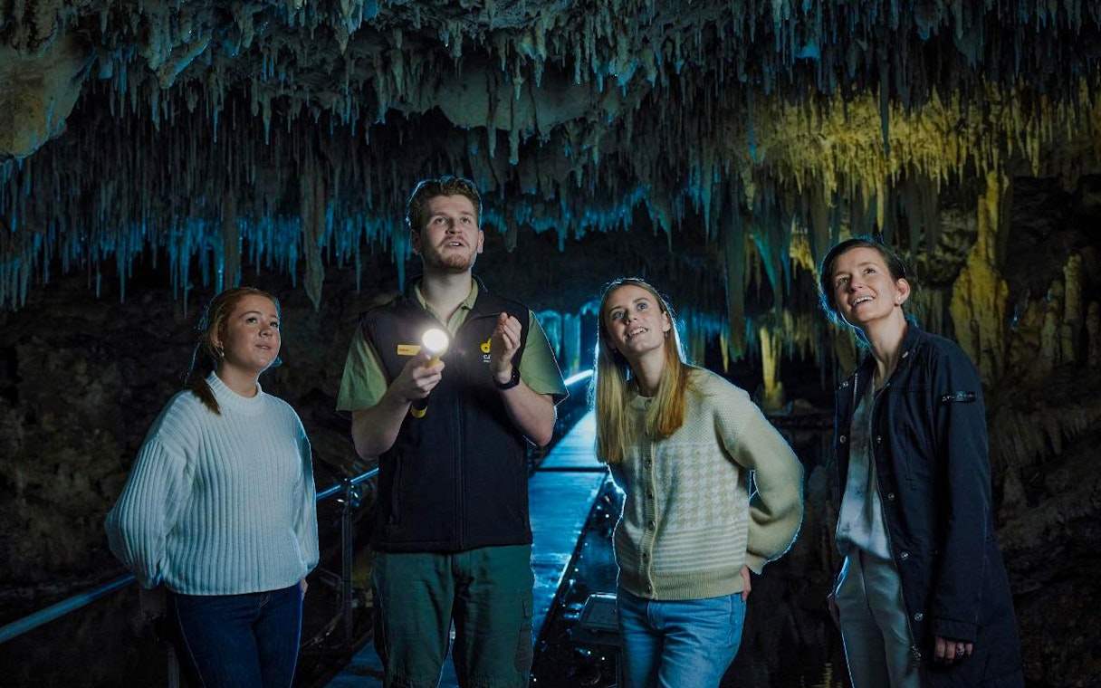 Group exploring stalactites in Margaret River Caves.