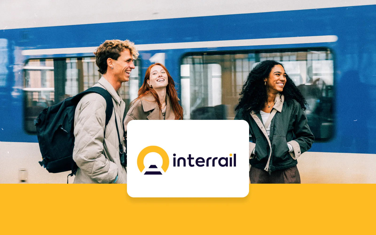 Travelers smiling at a train station with Interrail Global Pass logo.