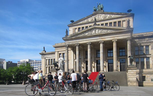 Cyclists gather in front of Berlin's Konzerthaus during a guided bike tour.