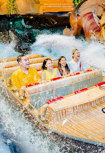 Visitors enjoying a water ride at Dunia Fantasi Dufan Theme Park, Jakarta.