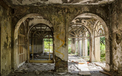 Abandoned building interior with arched windows, Dubrovnik tour site.