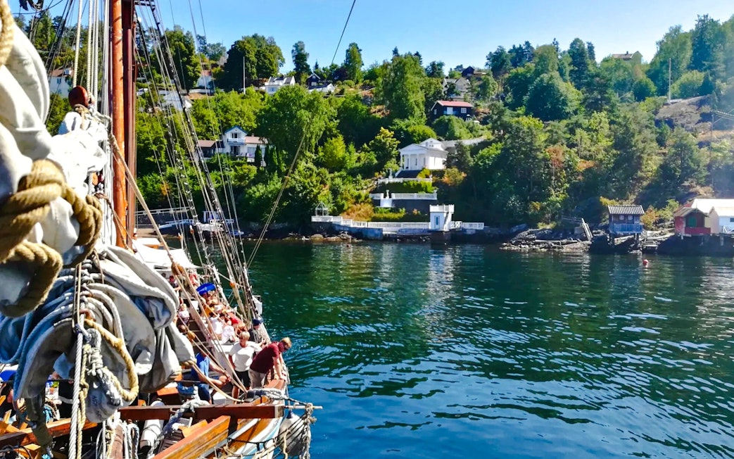 Sailing ship near summer cottages along Oslofjord.