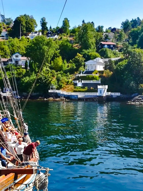 Sailing ship near summer cottages along Oslofjord.