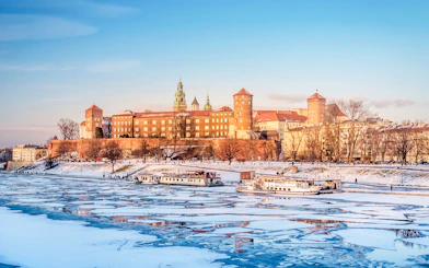 Wawel Castle in Krakow with frozen Vistula River in winter.