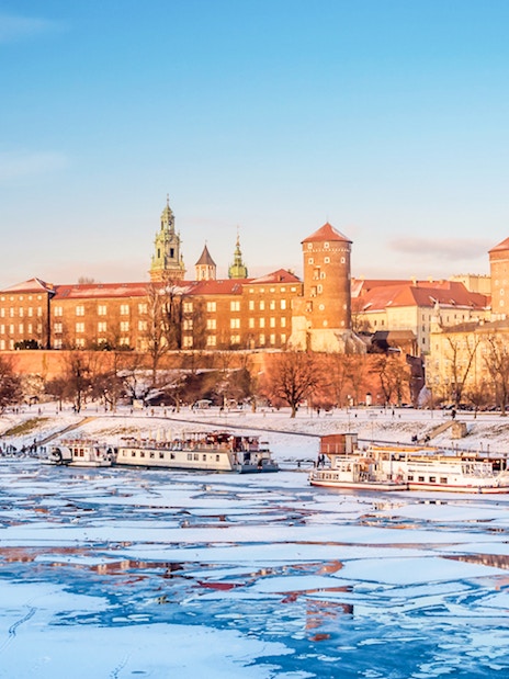 Wawel Castle in Krakow with frozen Vistula River in winter.