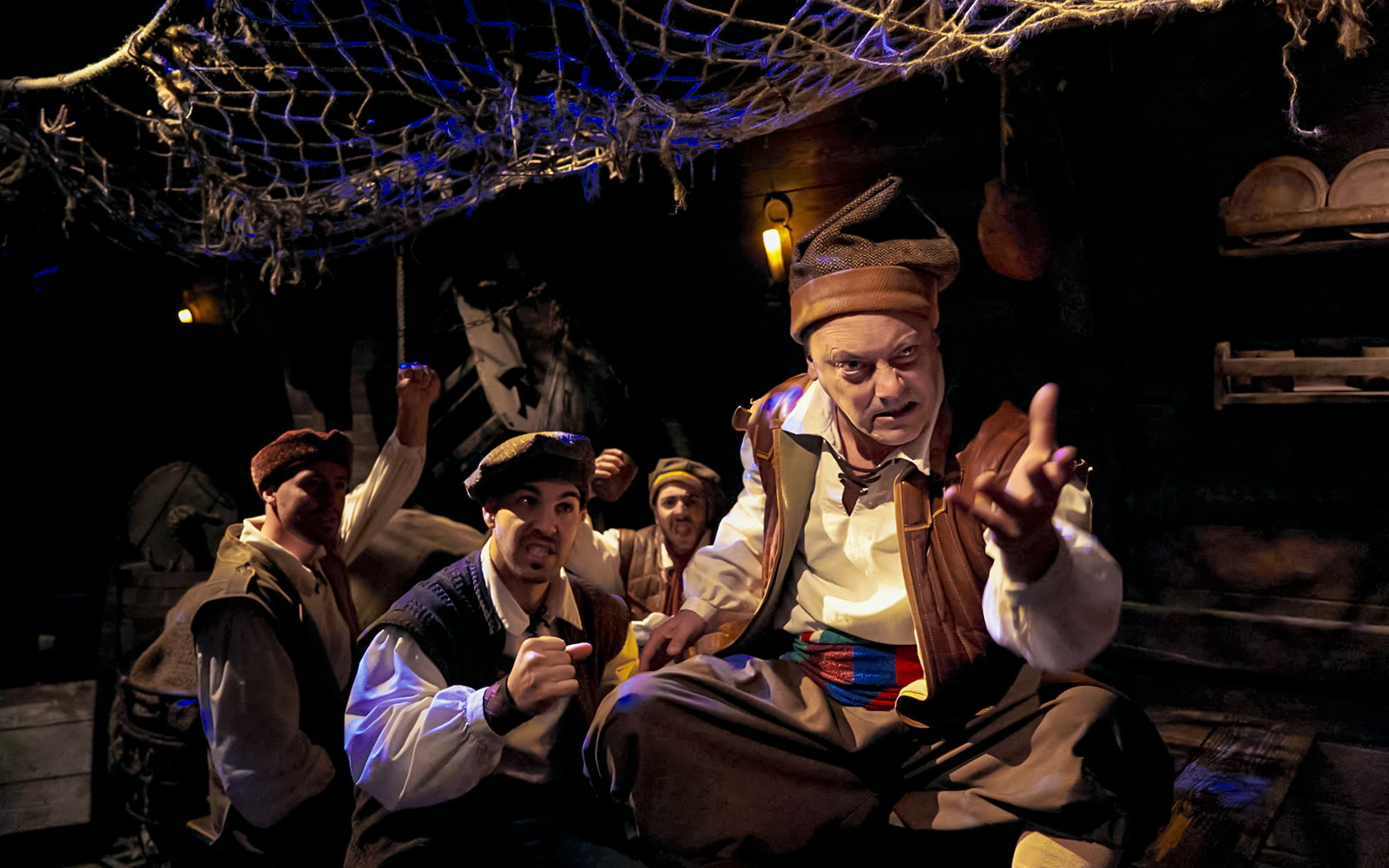 Pirates in a dimly lit ship interior, part of Allende la Mar Océana experience.