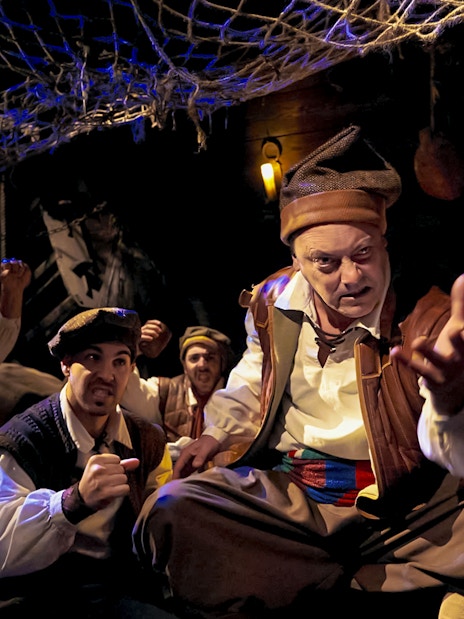 Pirates in a dimly lit ship interior, part of Allende la Mar Océana experience.