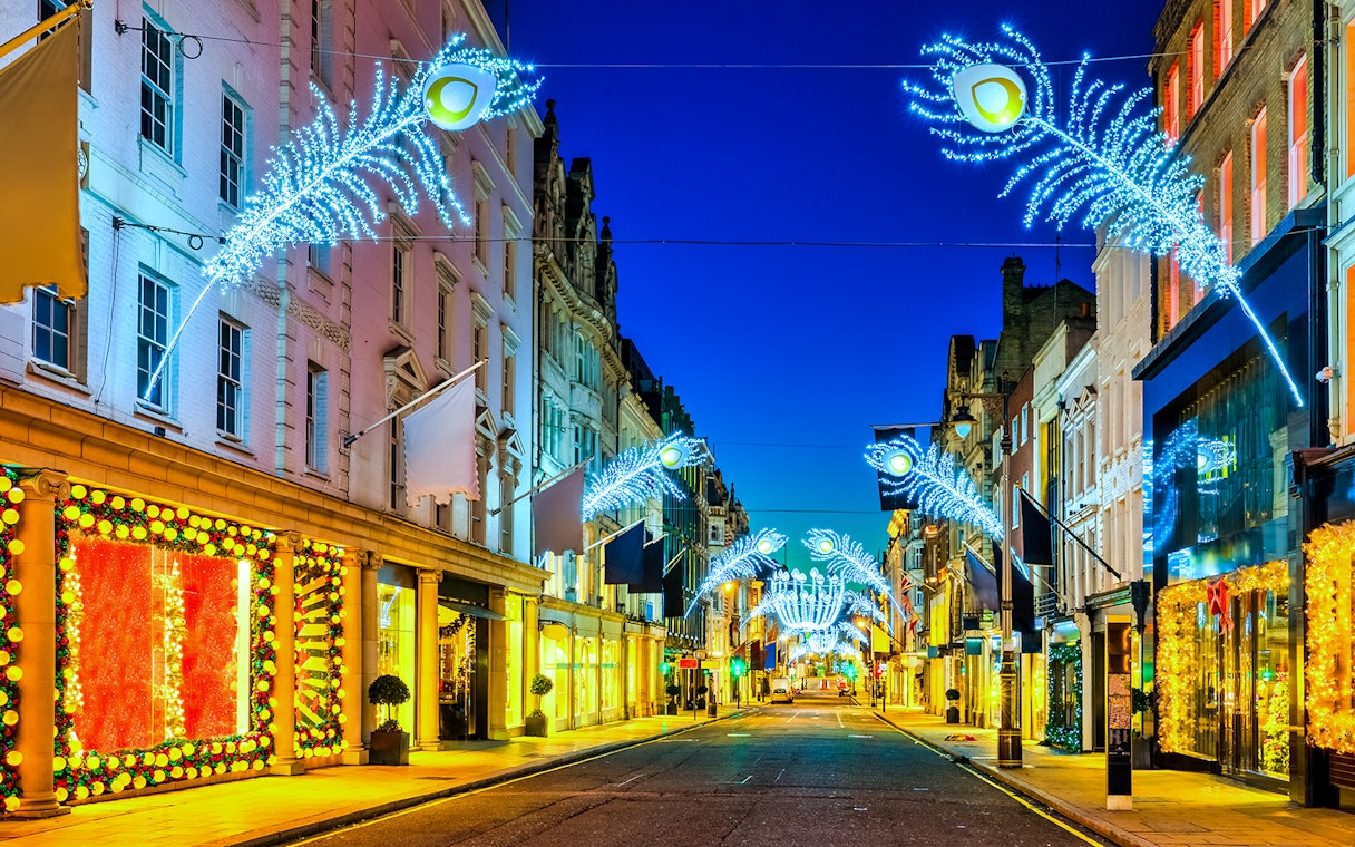 London street with Christmas lights and decorations during Big Bus Christmas Lights Night Tour.