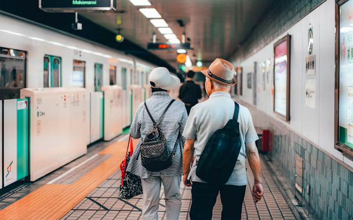 Elderly couple walking on a train platform in Sapporo, Japan.
