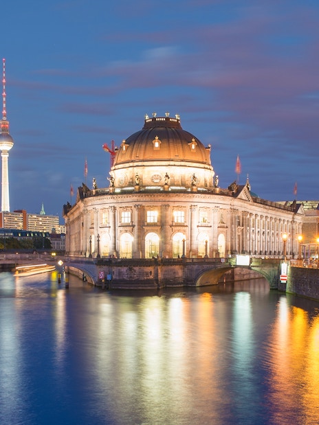 Bode Museum on Museum Island, Berlin, with TV Tower in the background at dusk.