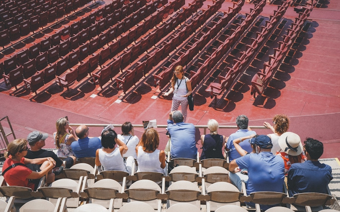 Tour group listening to a guide inside Verona Arena.