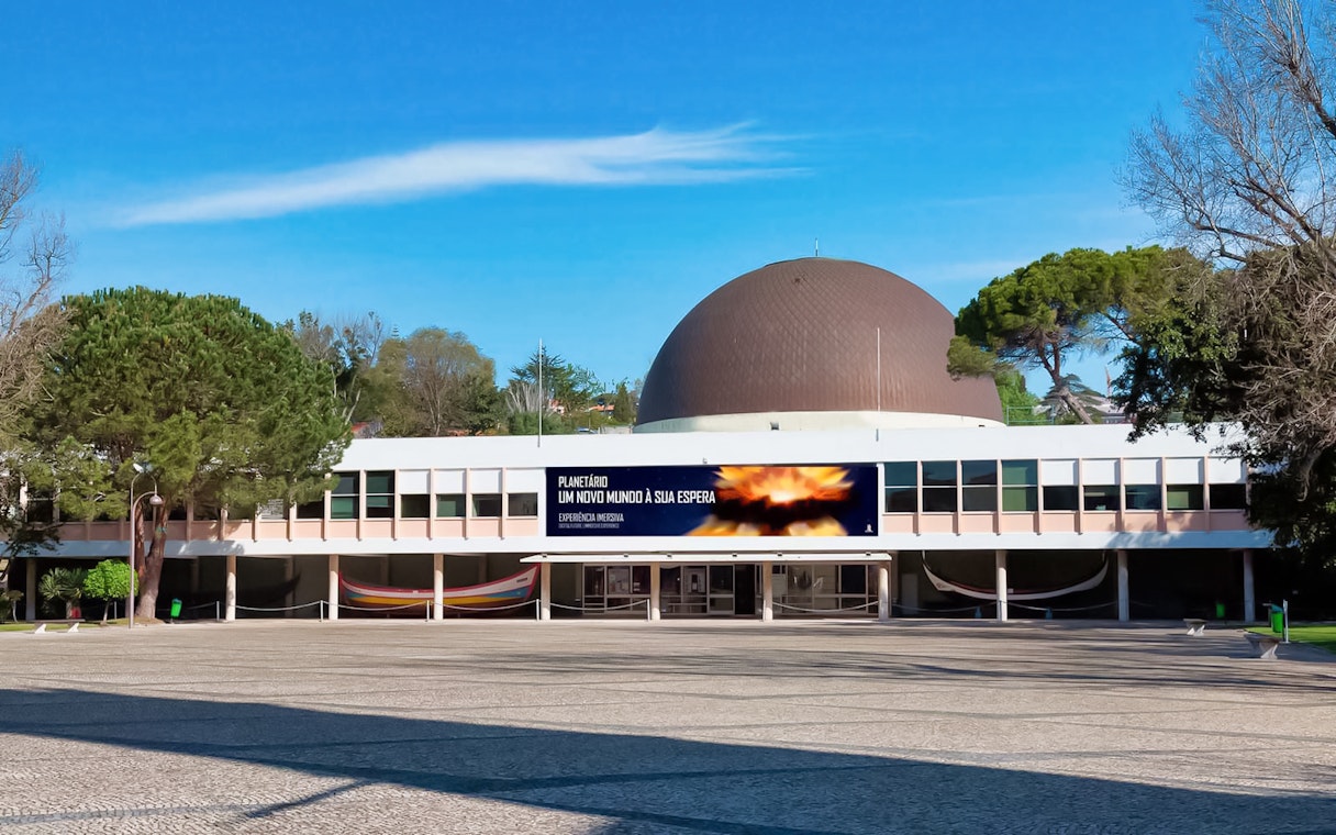Navy Planetarium building with a large dome and surrounding trees.
