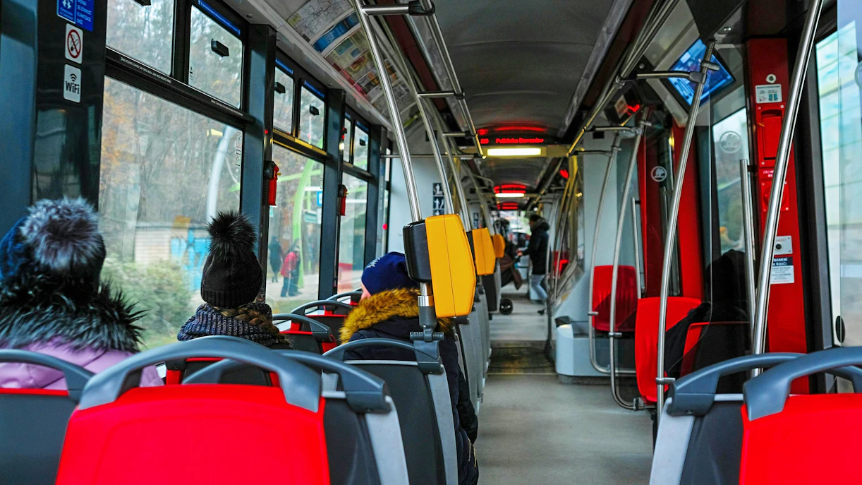 Interior of a Prague tram with passengers seated, Czech Republic, November 2018.