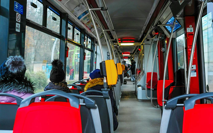 Interior of a Prague tram with passengers seated, Czech Republic, November 2018.
