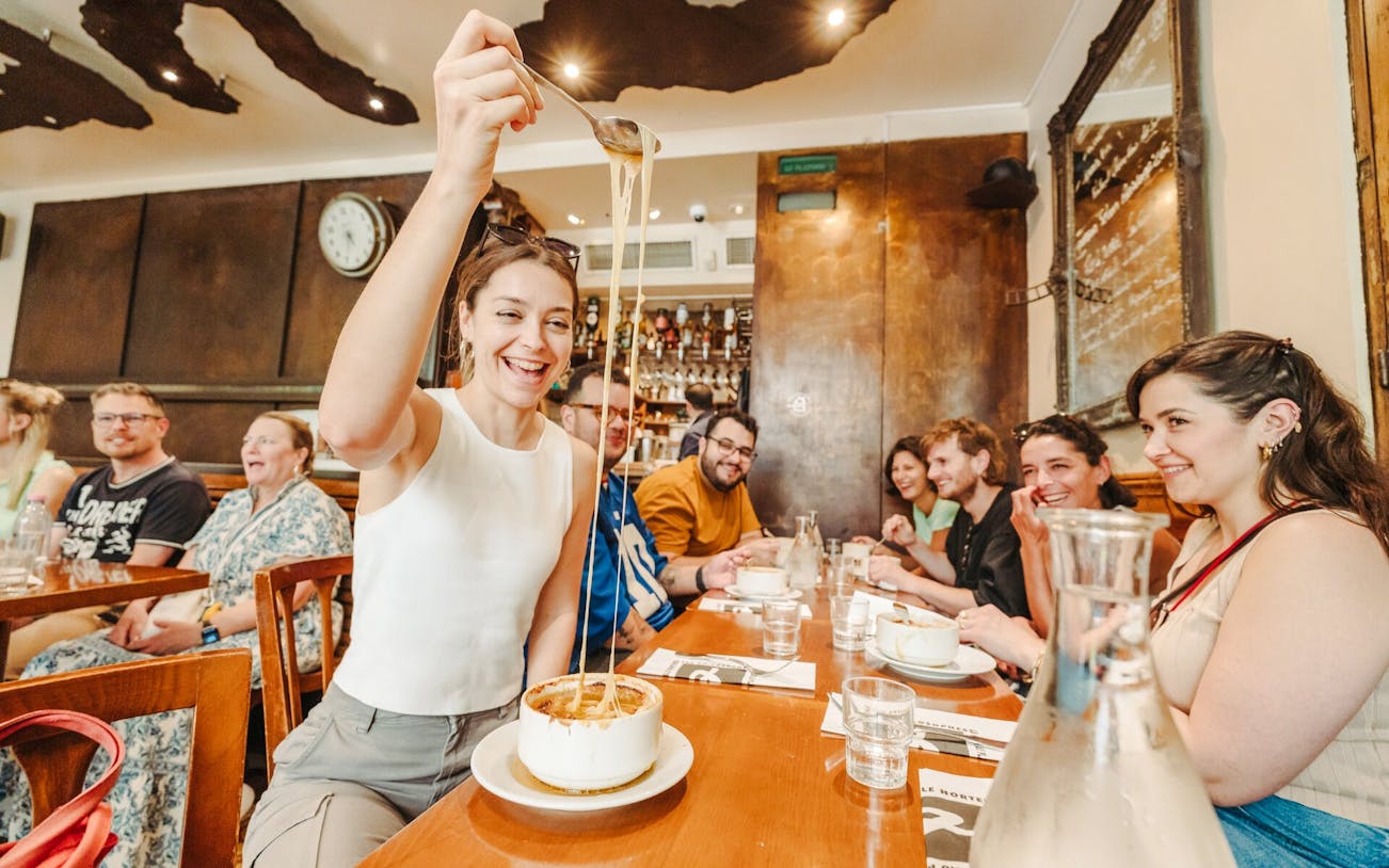 Group enjoying French onion soup on the Ultimate Paris Food Tour.