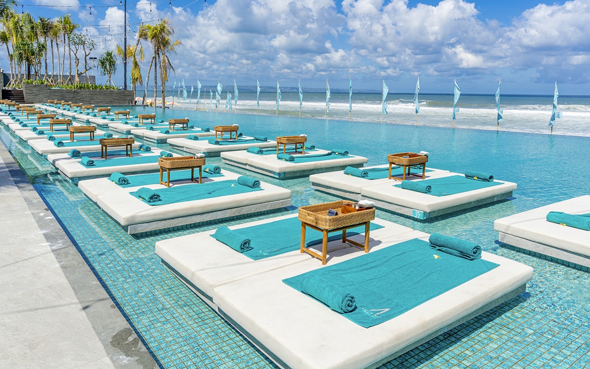 Sun loungers by the pool at Atlas Night Club with ocean view, one day pass includes drink.