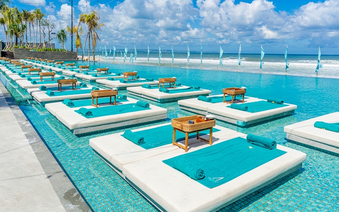 Sun loungers by the pool at Atlas Night Club with ocean view, one day pass includes drink.