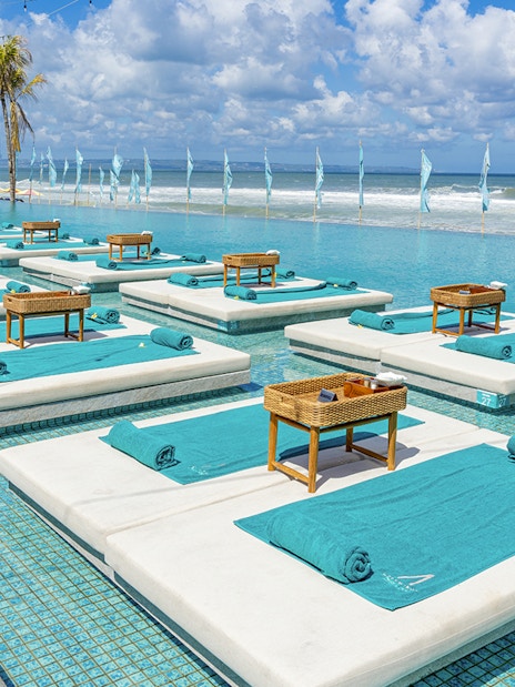Sun loungers by the pool at Atlas Night Club with ocean view, one day pass includes drink.