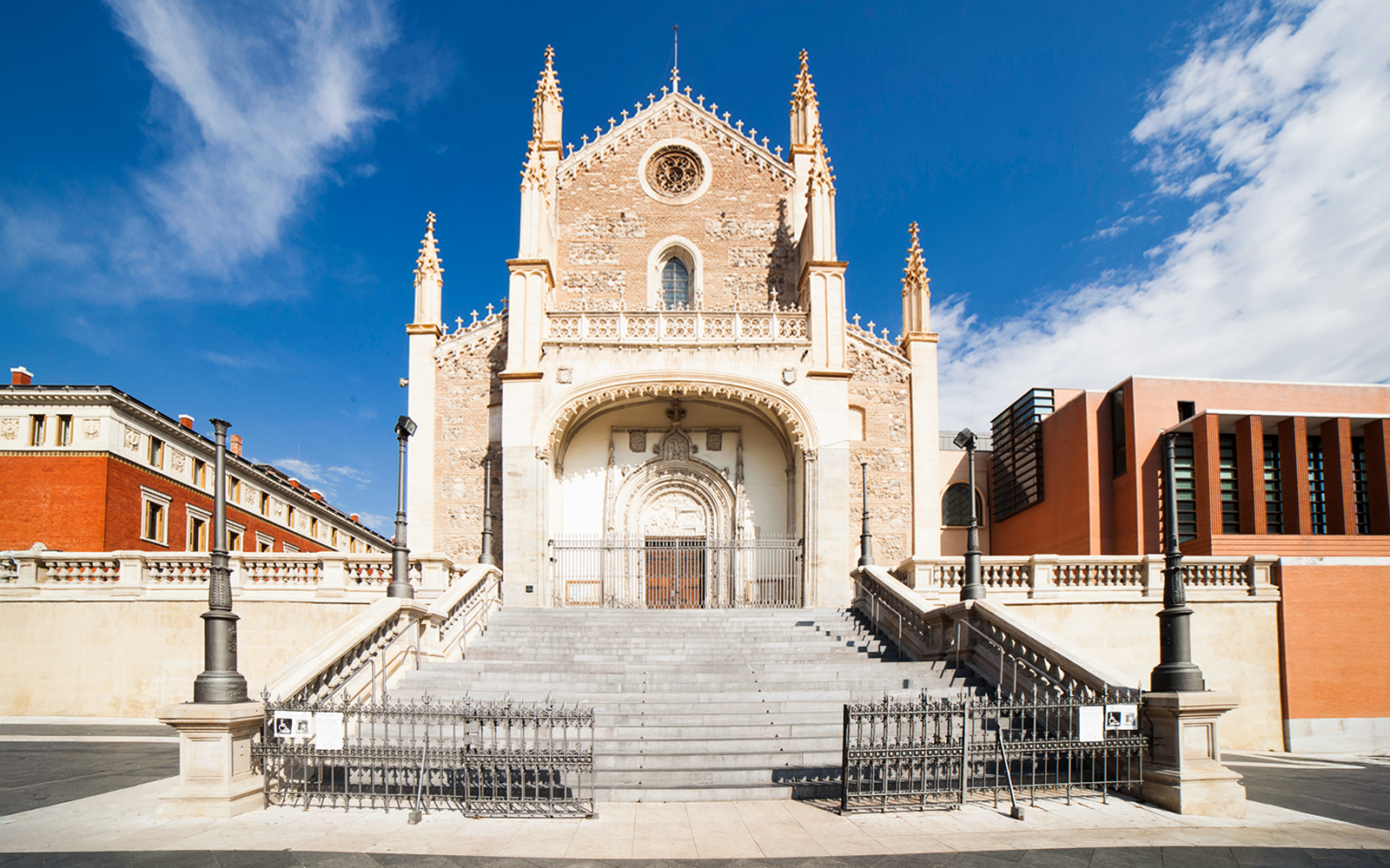Los Jeronimos Church facade with ornate entrance and steps in Madrid, Spain.
