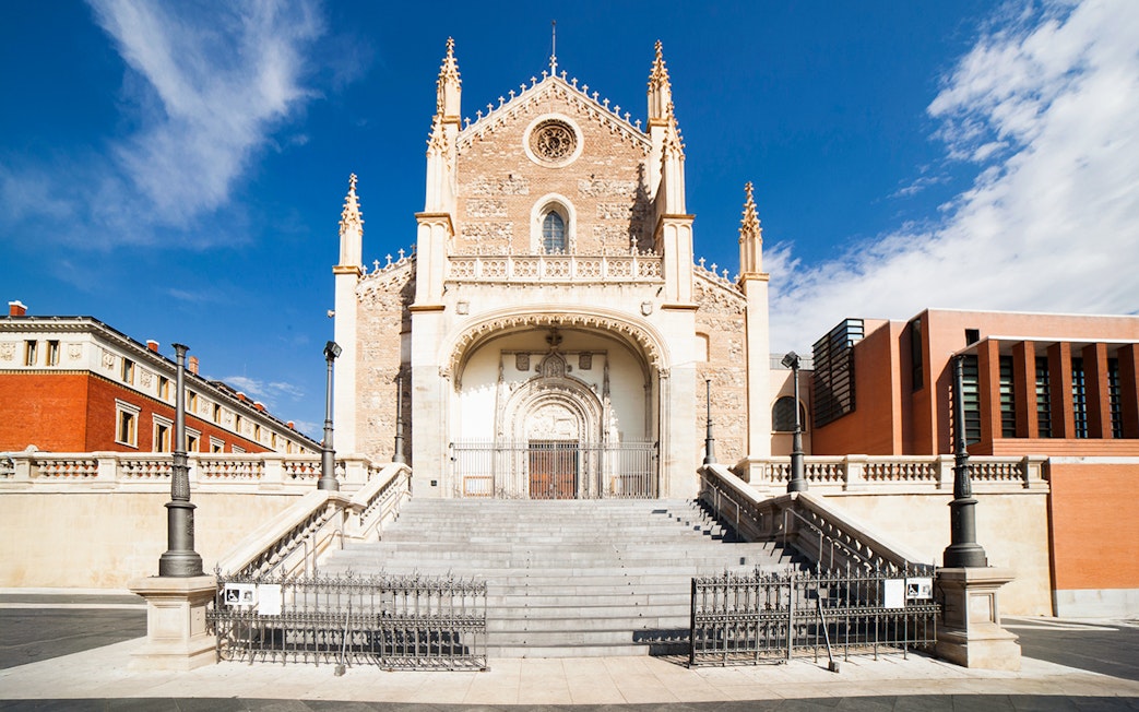 Los Jeronimos Church facade with ornate entrance and steps in Madrid, Spain.