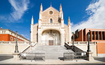 Los Jeronimos Church facade with ornate entrance and steps in Madrid, Spain.
