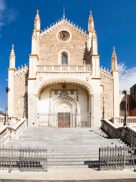 Los Jeronimos Church facade with ornate entrance and steps in Madrid, Spain.