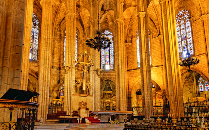 Barcelona Cathedral interior with ornate altar and stained glass windows.