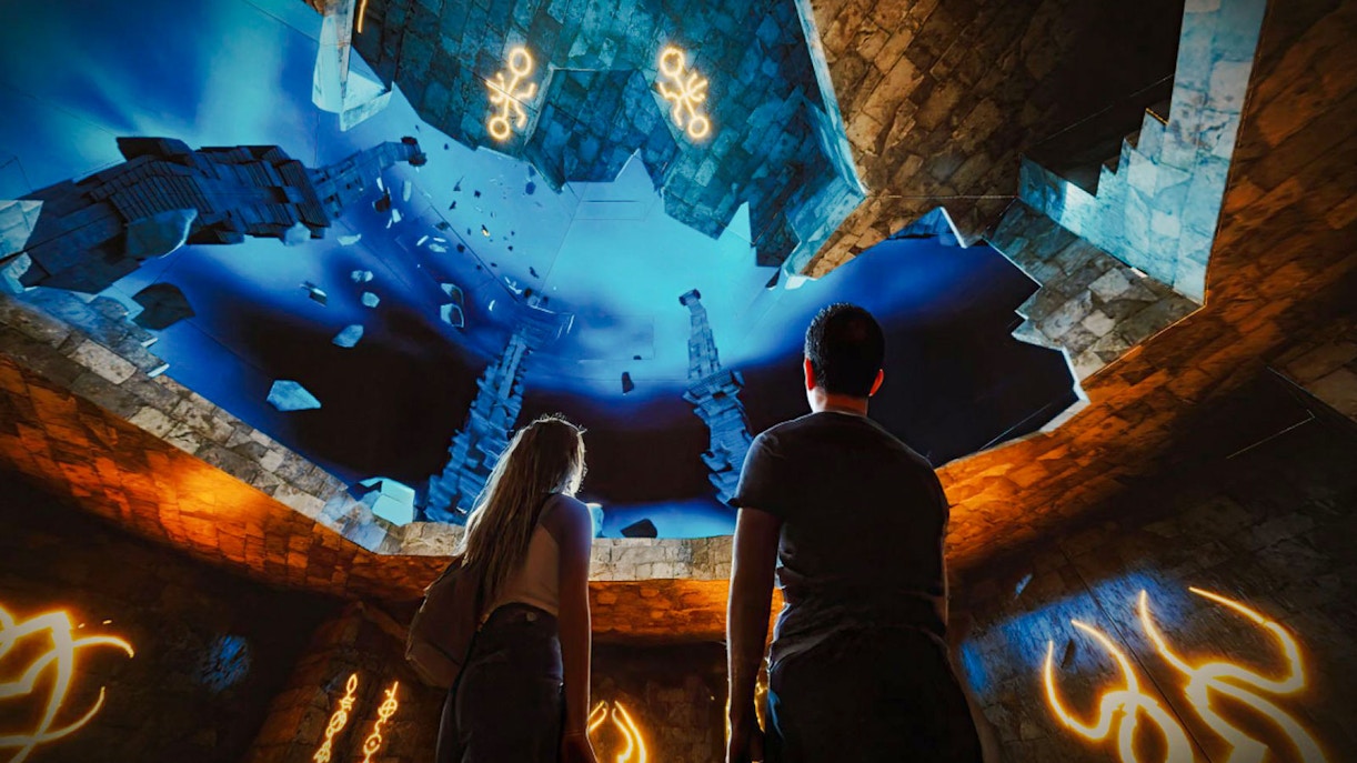 Visitors exploring immersive underwater scene at The Lost World Aquarium.