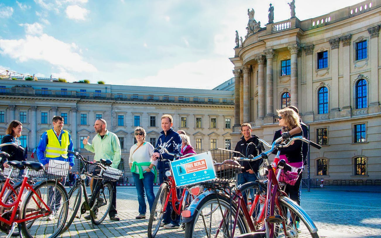 Group on a guided bike tour in front of Berlin's historic Humboldt University.