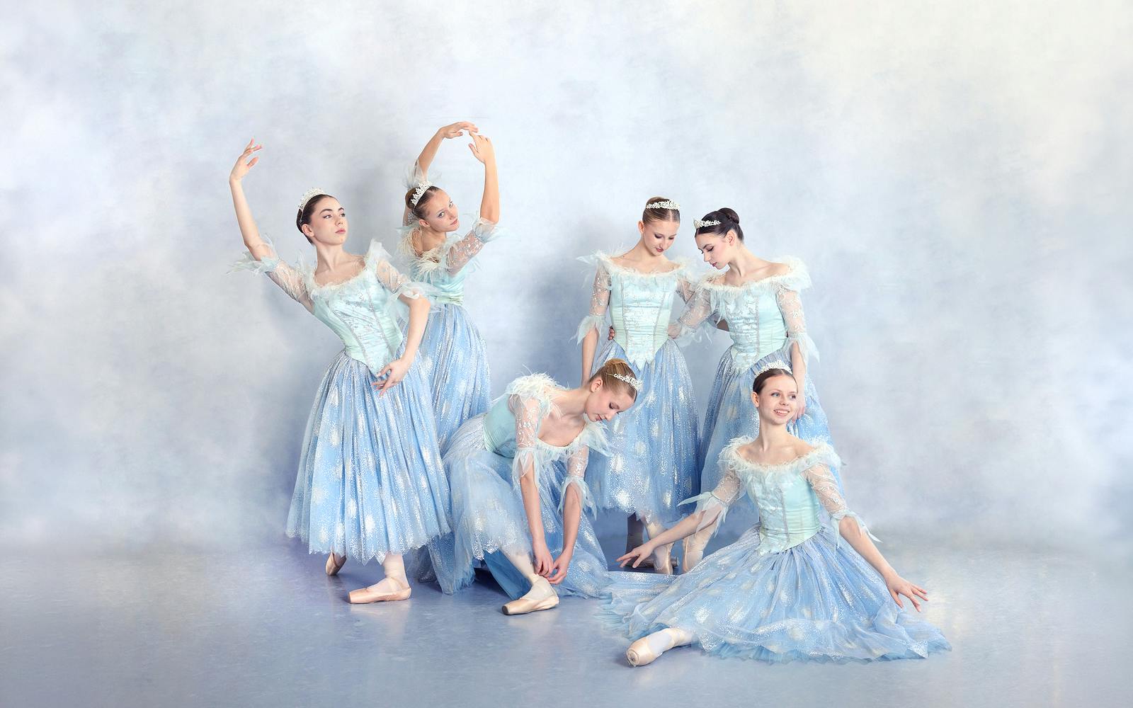Ballet dancers in blue costumes performing at a gala in Prague's Old Town.