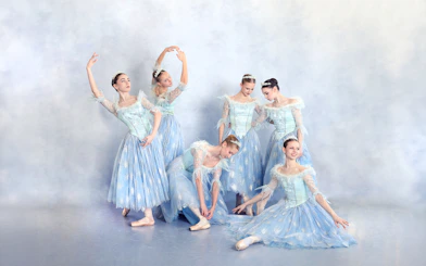 Ballet dancers in blue costumes performing at a gala in Prague's Old Town.