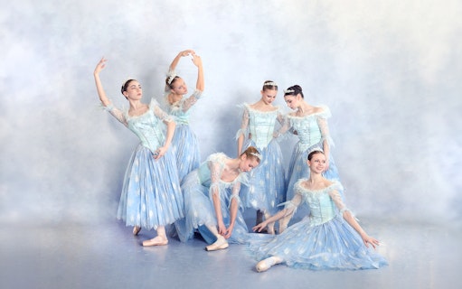 Ballet dancers in blue costumes performing at a gala in Prague's Old Town.