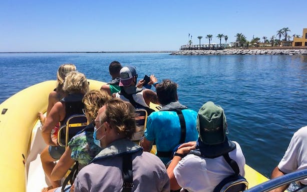 Tourists on a boat tour in Algarve, heading towards Benagil Caves from Portimão.
