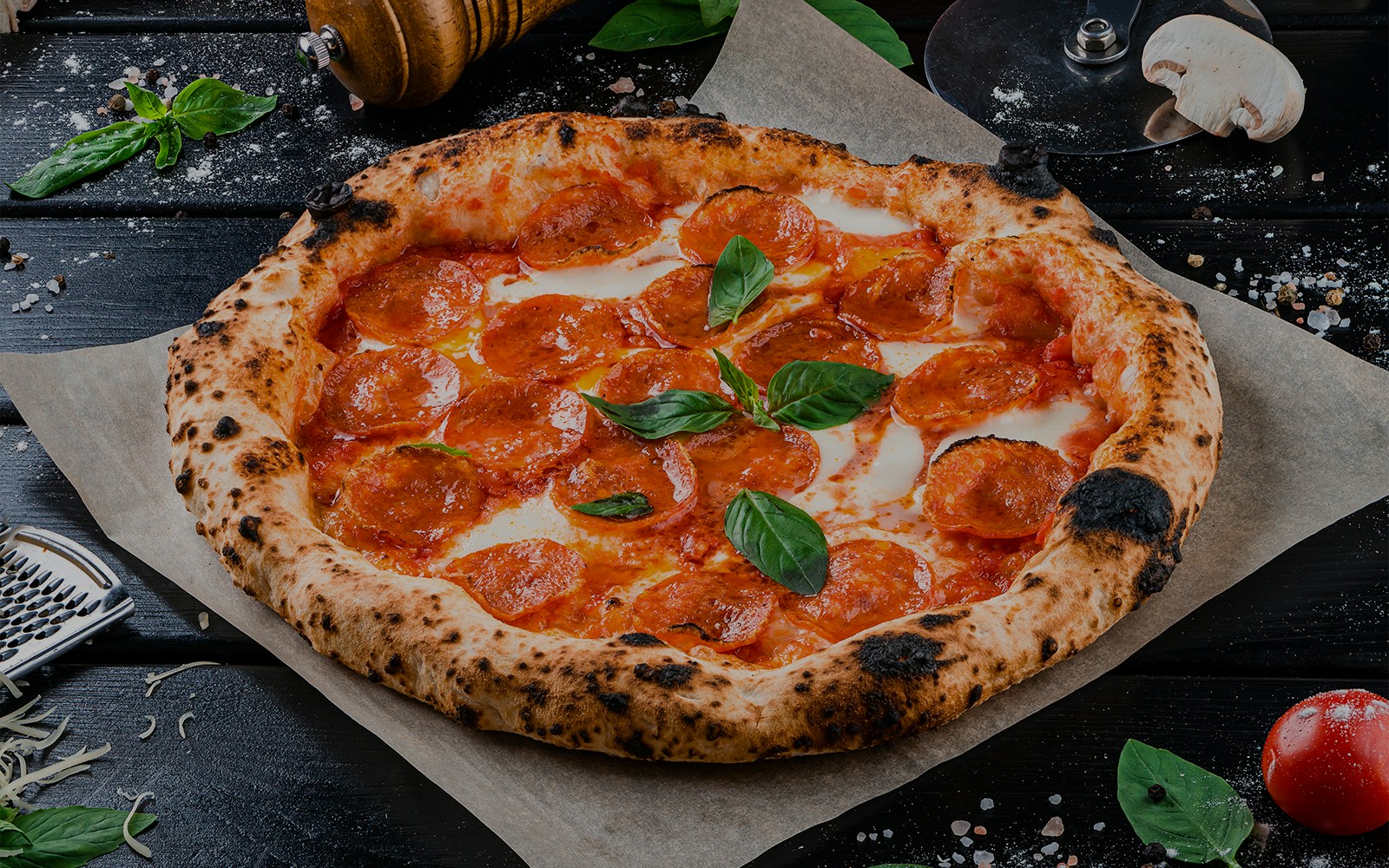 Dining experience at O2 Restaurants with a freshly baked pizza on a wooden table.