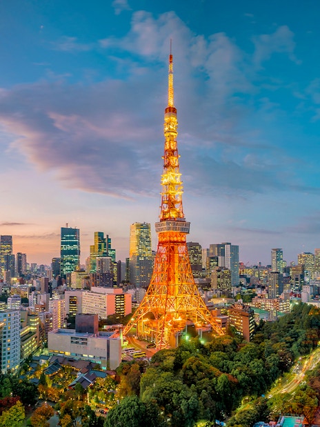 Tokyo Tower illuminated at sunset with cityscape, Tokyo.