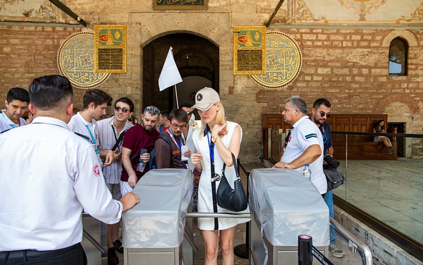Visitors entering Topkapi Palace during a guided tour in Istanbul.
