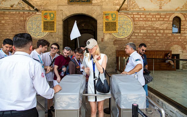 Visitors entering Topkapi Palace during a guided tour in Istanbul.
