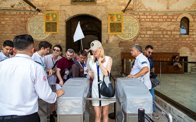 Visitors entering Topkapi Palace during a guided tour in Istanbul.