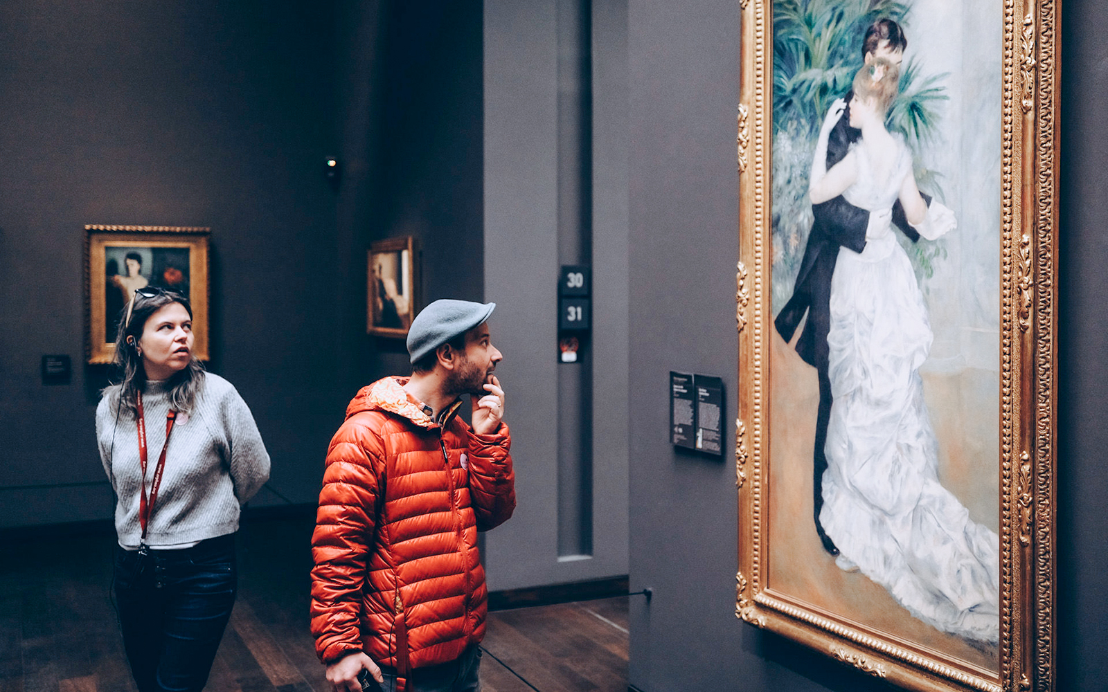 Tourists viewing artwork inside Orsay Museum, Paris.