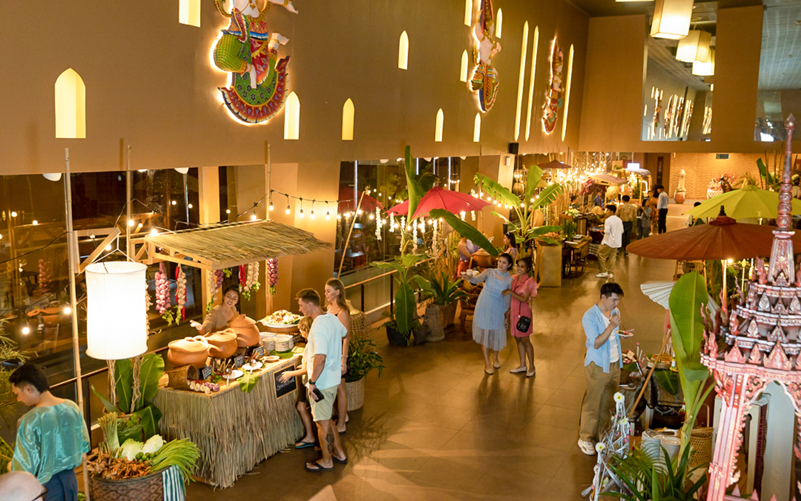Siam Niramit Phuket show venue with food stalls and visitors exploring.