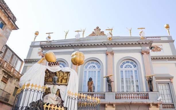 Museum Dalí facade with surreal sculptures and ornate architecture in Figueres, Spain.