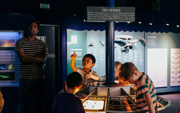 Children engaging with "The Orrery" exhibit at the International Antarctic Centre, Christchurch.