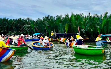 People in traditional basket boats on a river in Coconut Village, Da Nang.