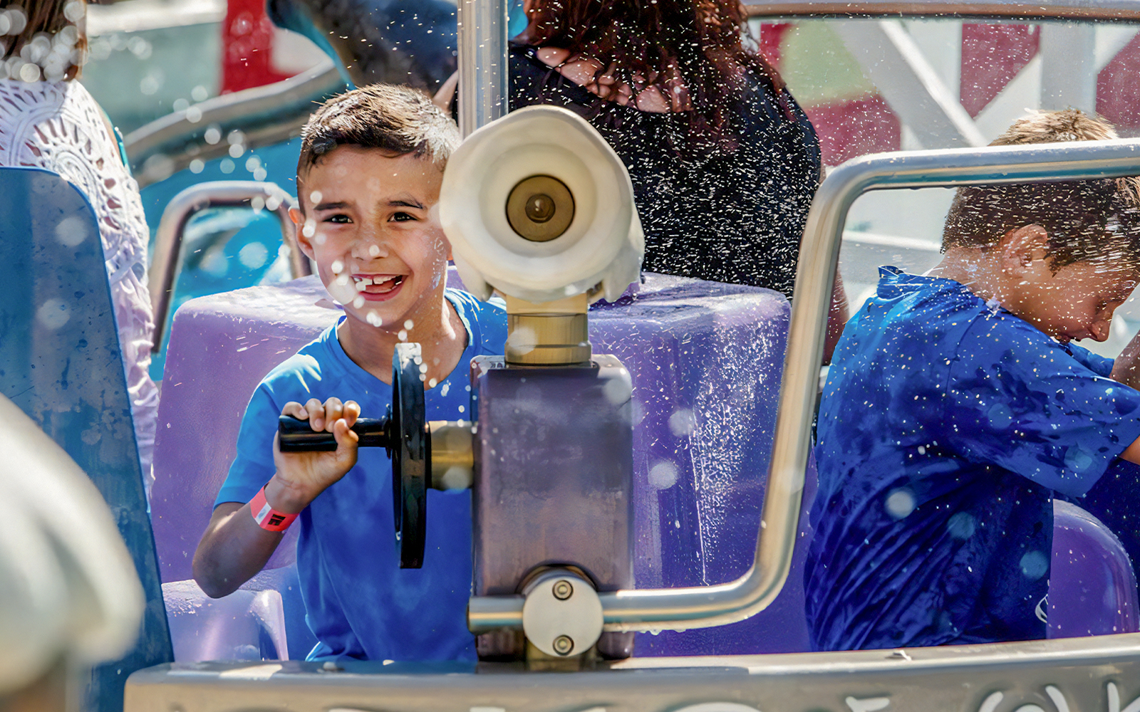 Splash Bash ride at Parque De Atracciones De Madrid with colorful water jets and excited riders.