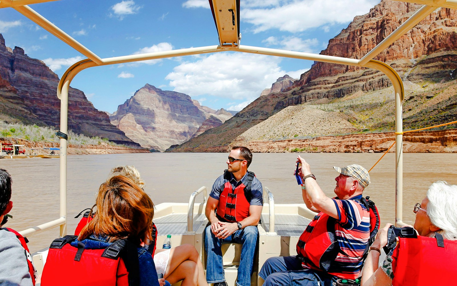 Guests on a boat during Grand Canyon West Rim helicopter tour with floor landing and boat ride.