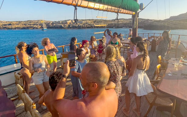 Group enjoying a cruise party on a boat near Ayia Napa's Blue Lagoon.