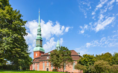 St. Georg Church with its tall spire under a blue sky, Hamburg.